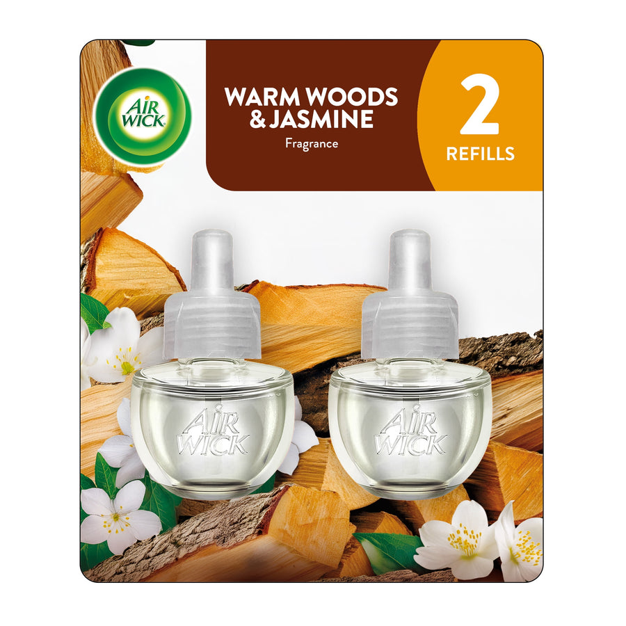 Two Air Wick plug-in scented oil refill bottles on a warm woods and jasmine package background.