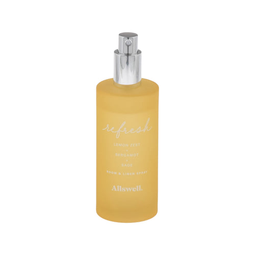 Frosted yellow glass spray bottle labeled 'refresh' Allswell room and linen spray with silver pump