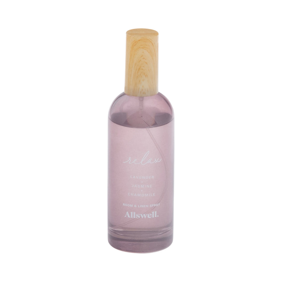 Tall translucent mauve Allswell 'Relax' room and linen spray bottle with wooden cap on white background.