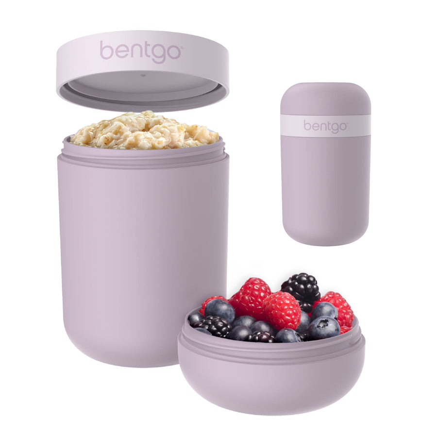 Orchid-colored Bentgo snack cup with dual-sealing lid and toppings compartment, filled with granola and berries