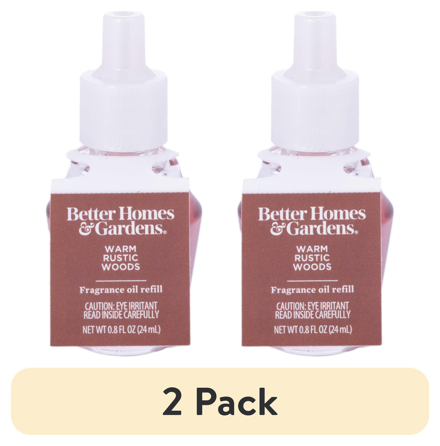 Two Better Homes & Gardens Warm Rustic Woods fragrance oil refill bottles side by side with a ‘2 Pack’ banner below.
