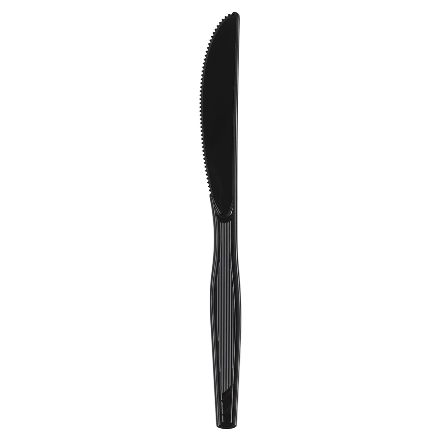 Single black disposable serrated plastic knife on white background, vertical orientation