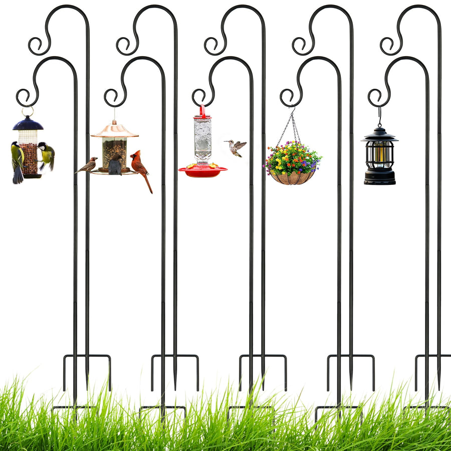 Five black metal shepherd hooks with three-prong bases holding assorted bird feeders and a hanging basket over grass.
