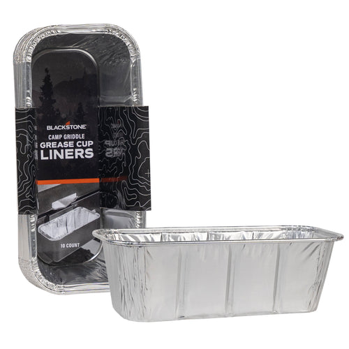 Stacked rectangular aluminum grease cup liners with branded Blackstone packaging visible behind one liner