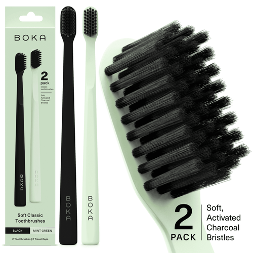 Two BOKA toothbrushes (mint green and black) with large close-up of charcoal bristles and packaging