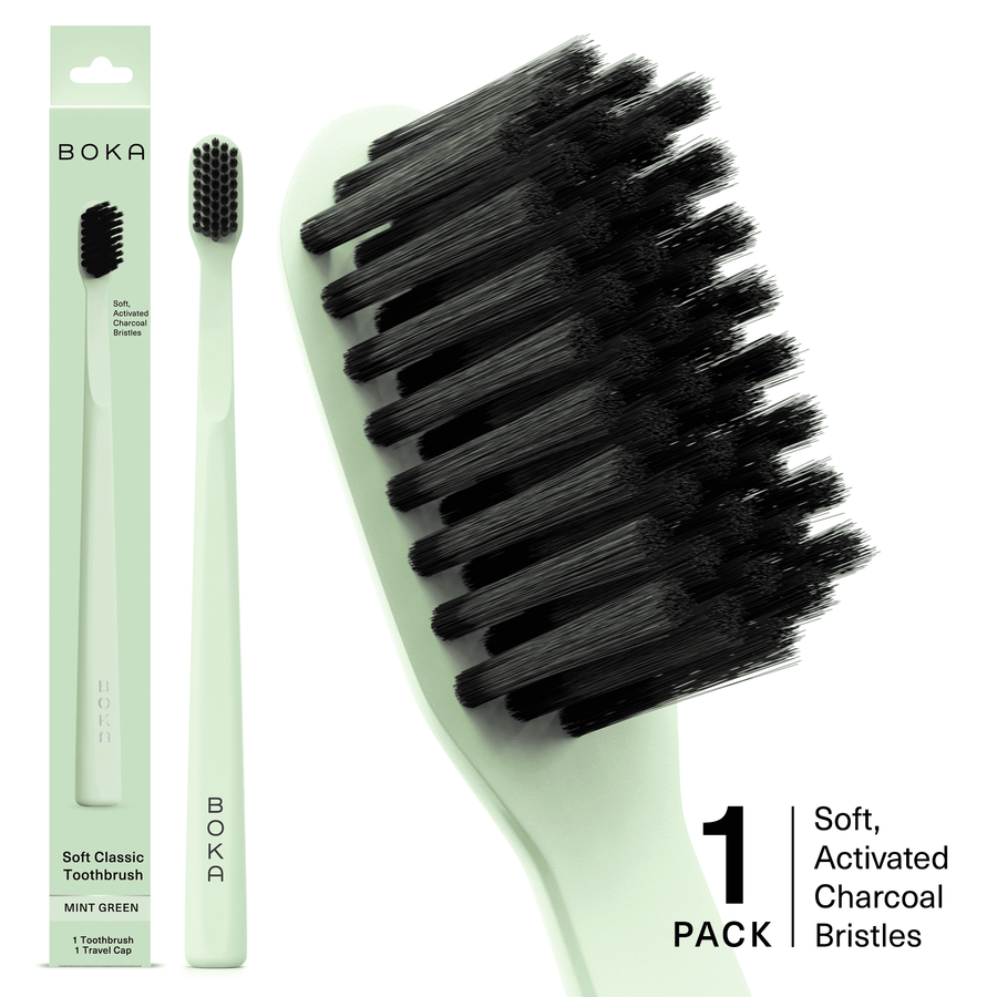 Mint green Boka toothbrush with black activated charcoal bristles shown alongside packaging and a close-up of the brush head.