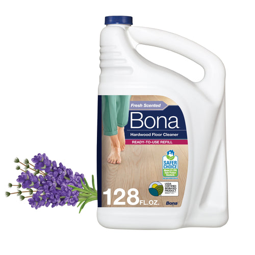 White Bona 128 fl. oz. hardwood floor cleaner jug with label and lavender sprig beside it on white background