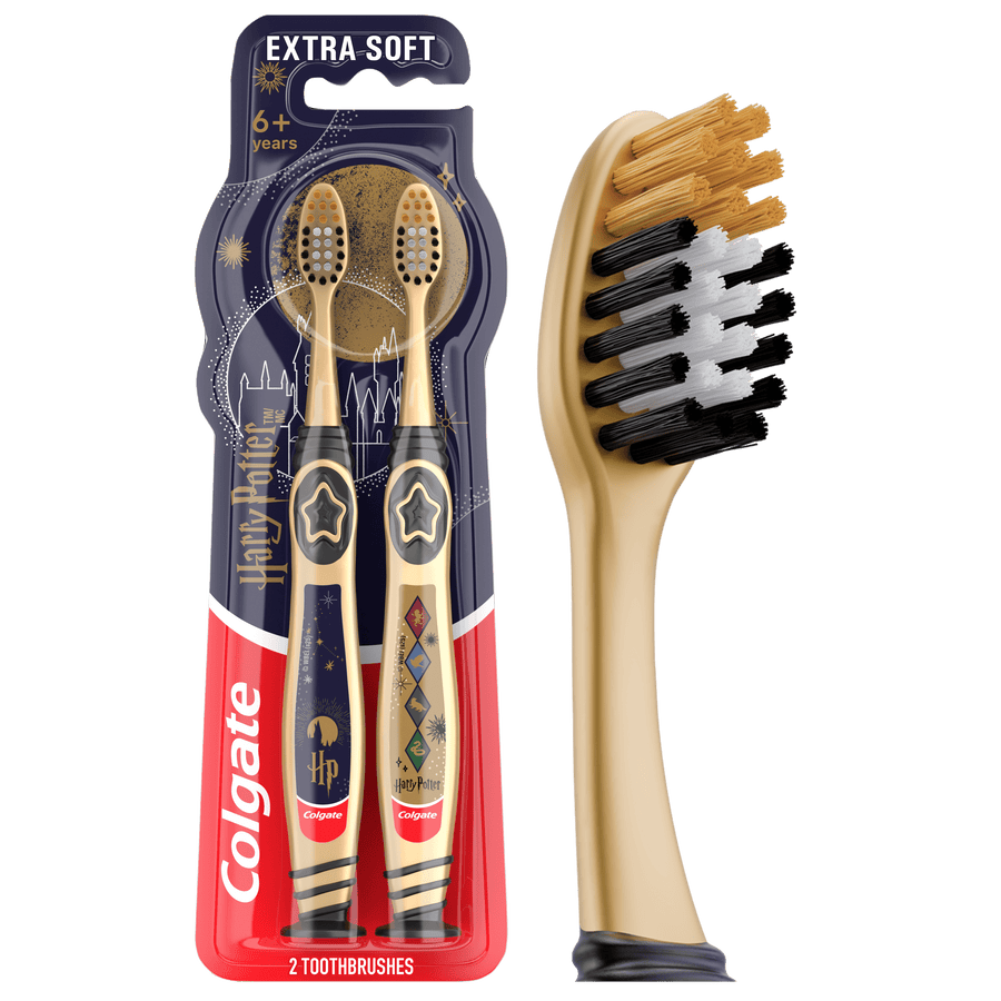 Packaged Colgate Harry Potter kids toothbrushes in gold-themed twin blister pack with branded handles