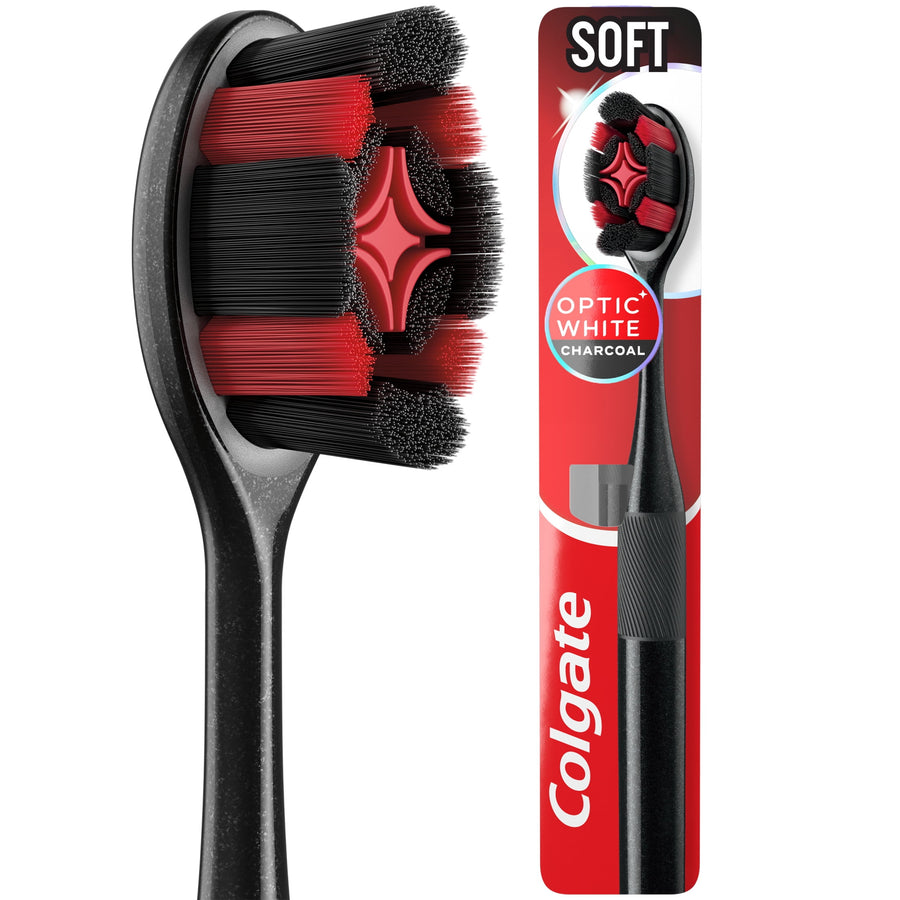 Close-up of a black and red Colgate Optic White charcoal toothbrush head and packaged toothbrush on white background.