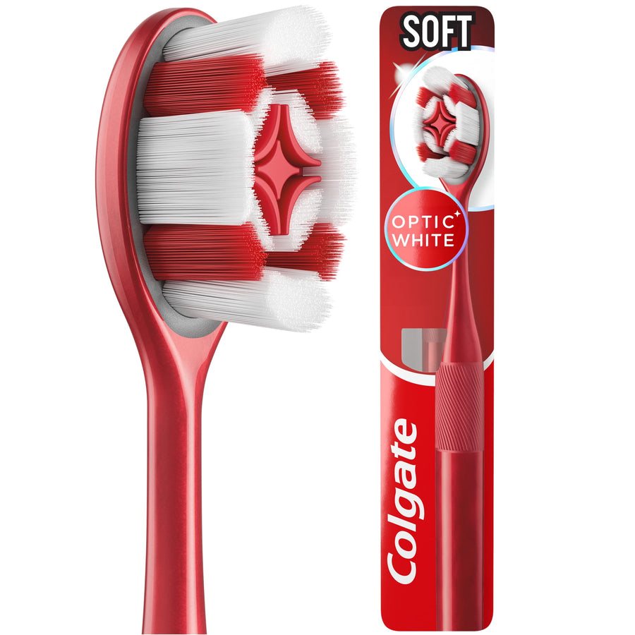 Red Colgate Optic White toothbrush handle and close-up of oval brush head with white and red multi-height bristles.