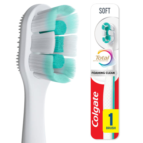 Close-up of Colgate Total Active Prevention toothbrush head showing soft mint-green and white bristles and side rubber polishing pad.