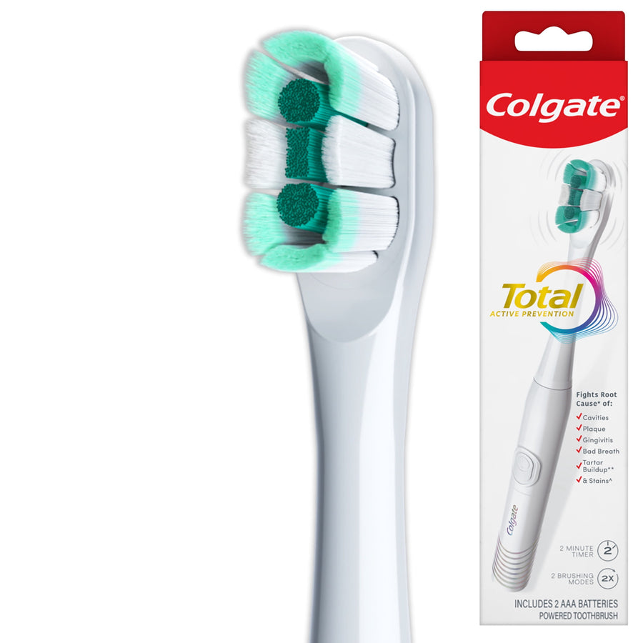 Close-up of a white Colgate Total electric toothbrush head with green-and-white bristles and product box at right
