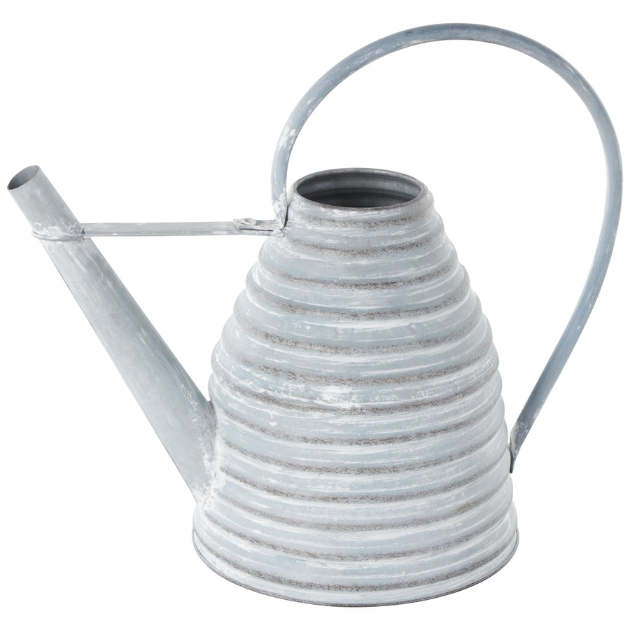 Close-up of a gray, beehive-shaped ribbed metal watering can with loop handle and long spout