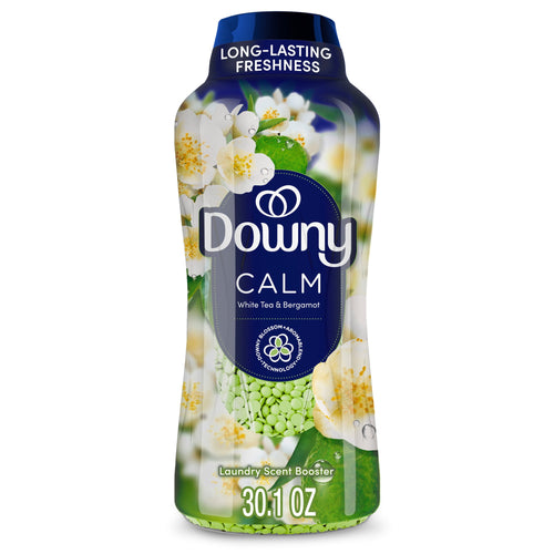 Close-up of a Downy Calm laundry scent booster bottle with white tea blossoms and green fragrance beads visible
