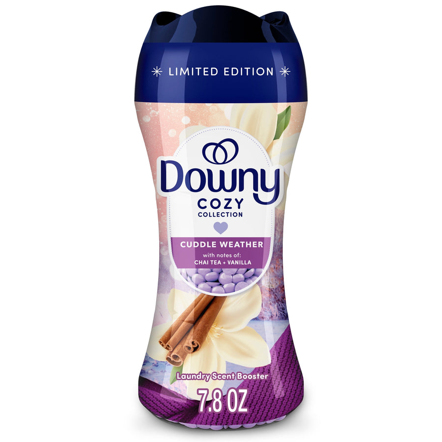 Close-up of a Downy Cozy Collection Cuddle Weather laundry scent booster bottle with purple cap and decorative cinnamon and vanilla graphics.