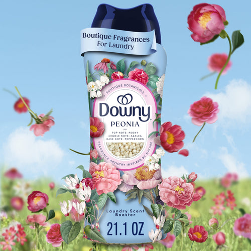 Close-up of a Downy Peonia in-wash scent booster bottle surrounded by illustrated pink peony flowers on a blue sky background