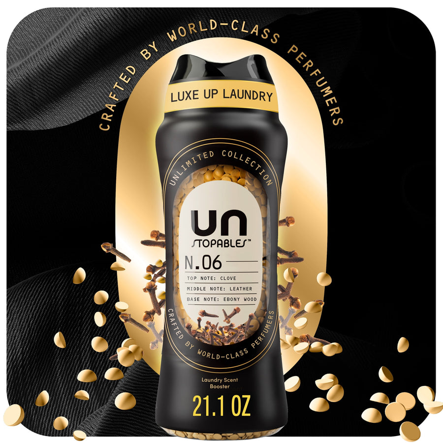Black Downy Unstopables N.06 bottle with visible scent beads and gold accents on a dark luxe background.