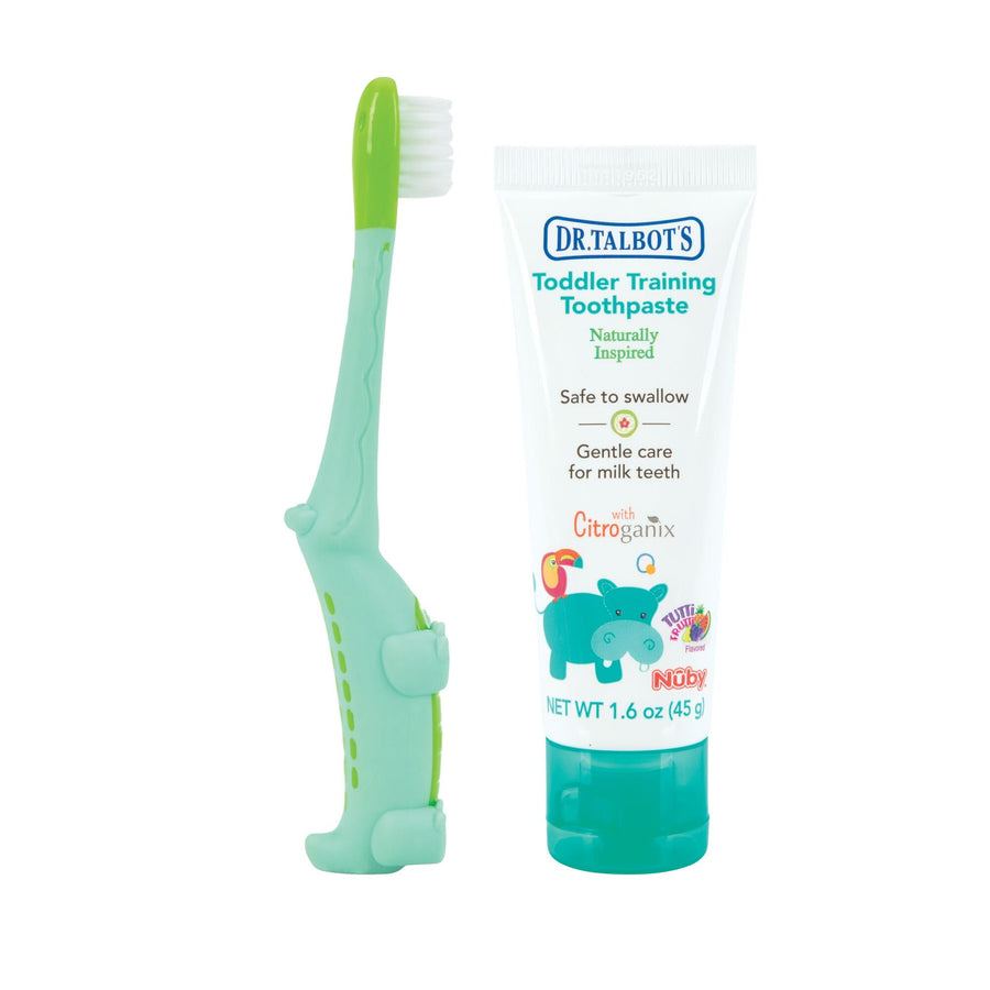 Dr. Talbot's toddler toothpaste tube and green alligator-shaped training toothbrush on white background