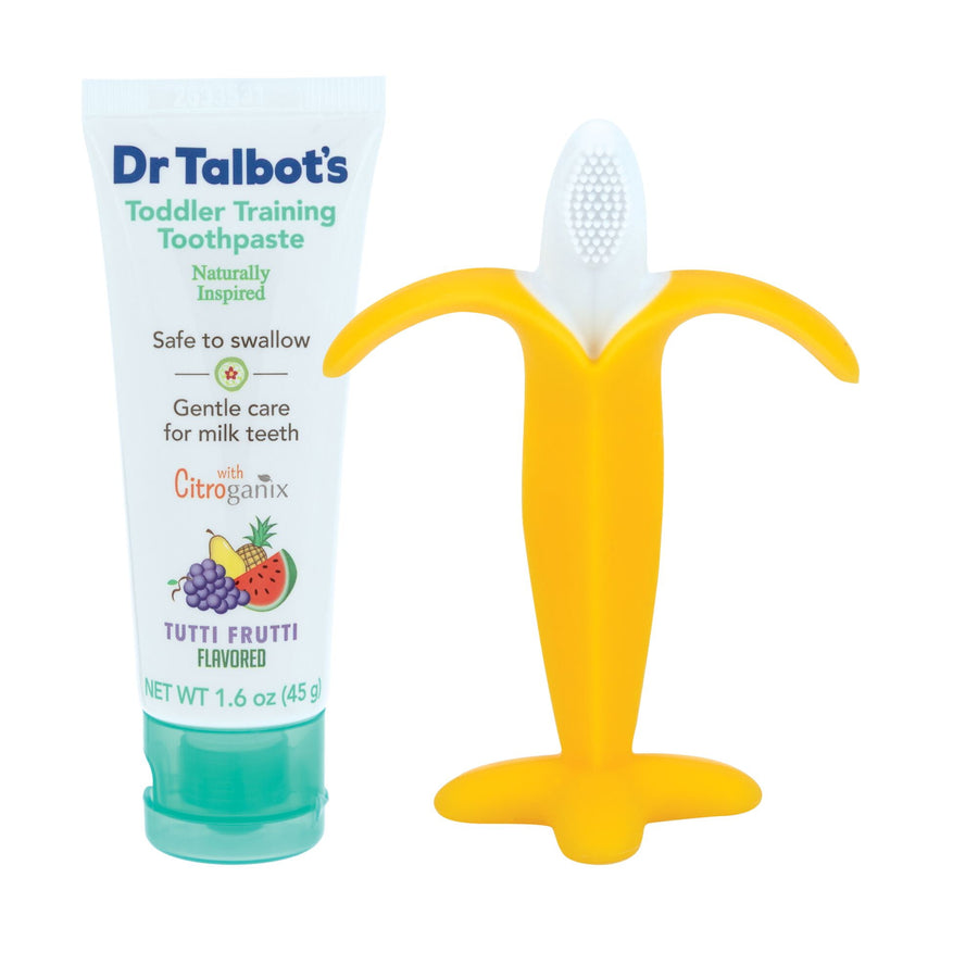 Tube of Dr. Talbot's toddler training toothpaste next to a yellow banana-shaped toddler toothbrush