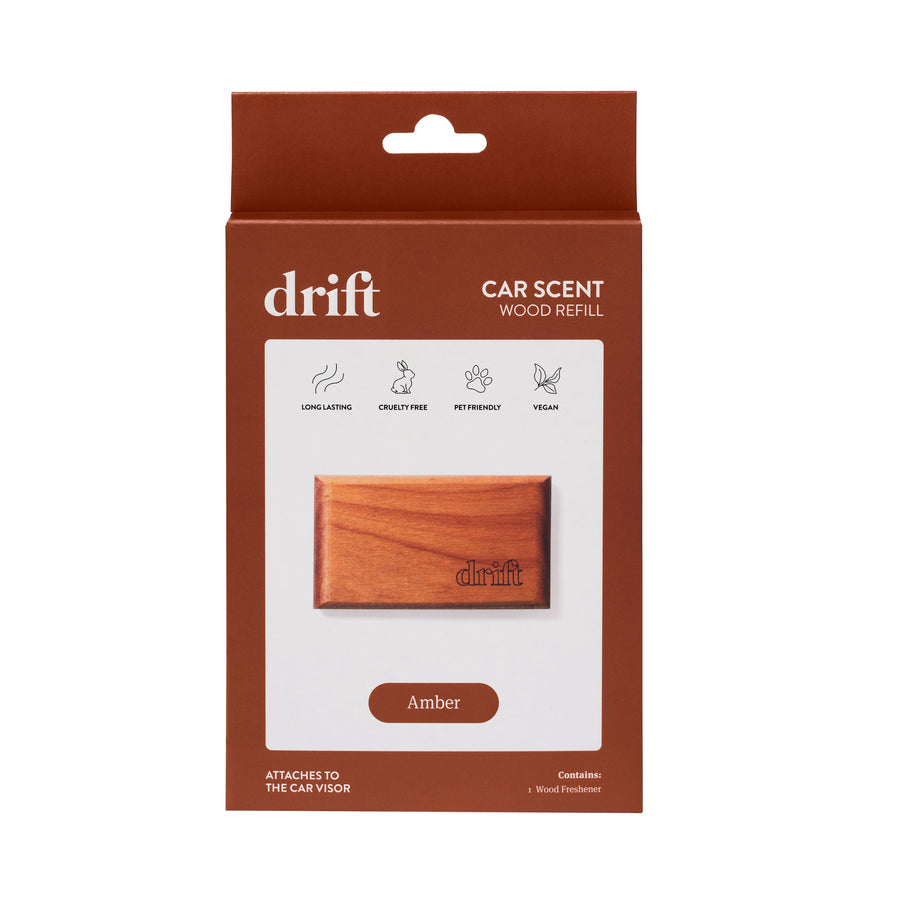 Front-facing retail box for Drift car scent wood refill in amber, showing a wood freshener image and amber label.