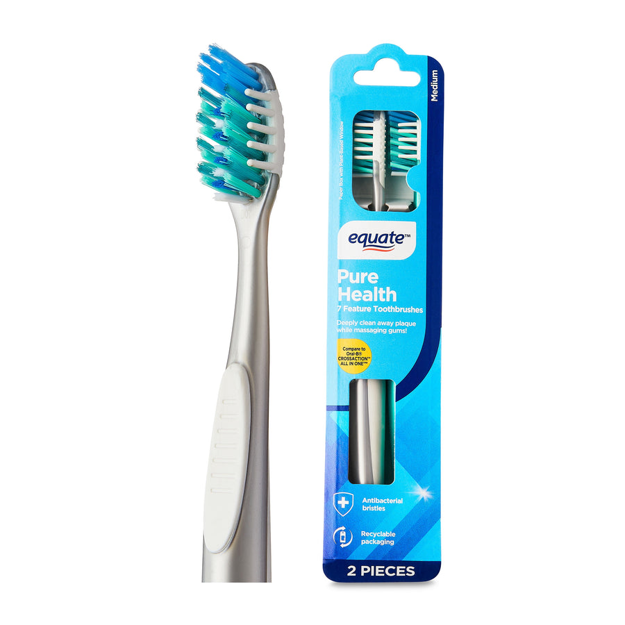 Close-up of an Equate Pure Health adult manual toothbrush head and matching blue product packaging showing medium bristles