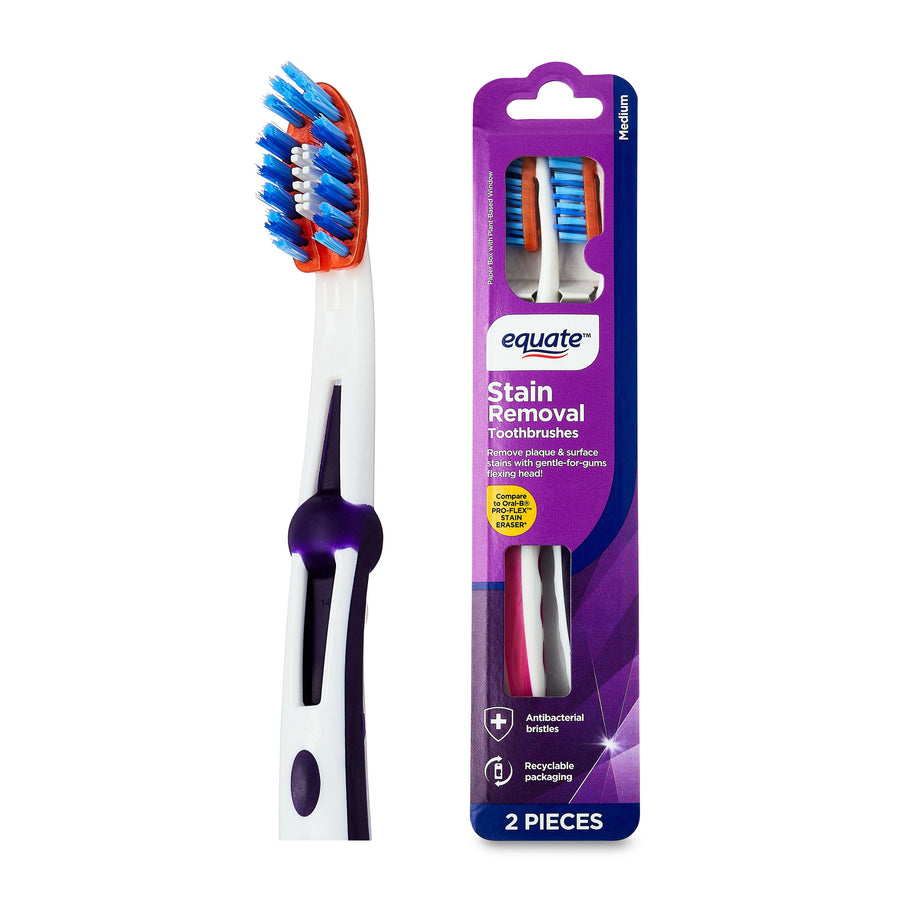 Equate Stain Removal toothbrush shown next to its purple retail blister pack, white handle with purple accents.