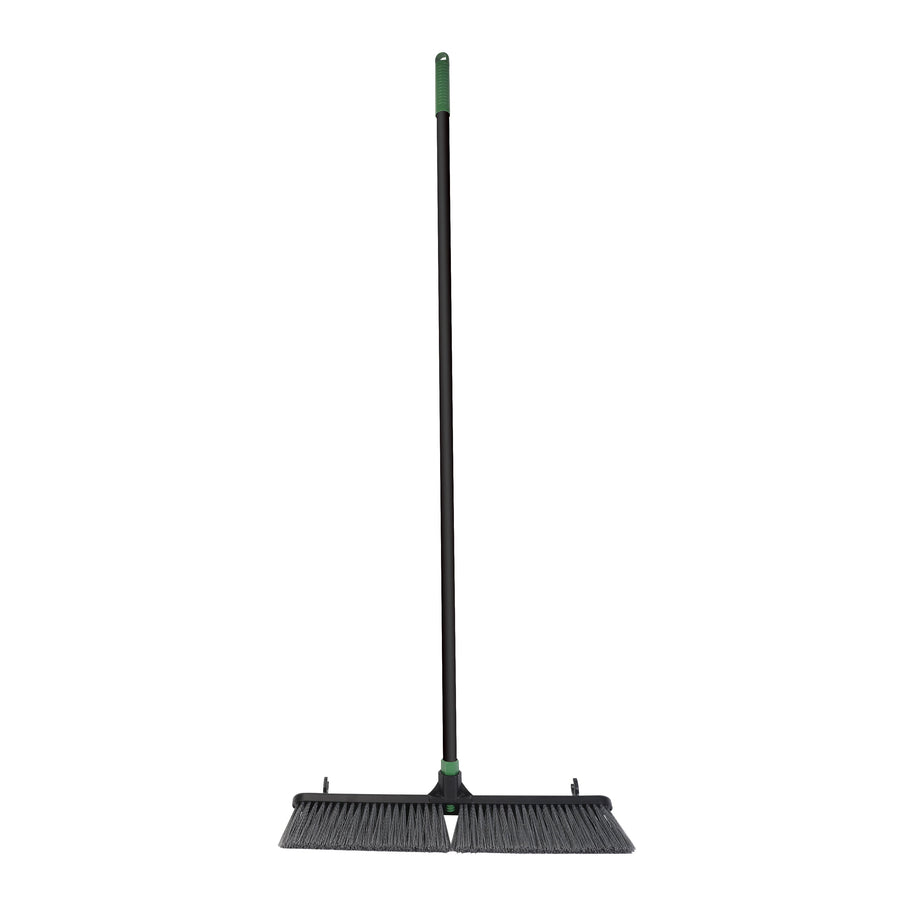 Full-length studio photo of a black push broom with green handle and 24-inch head