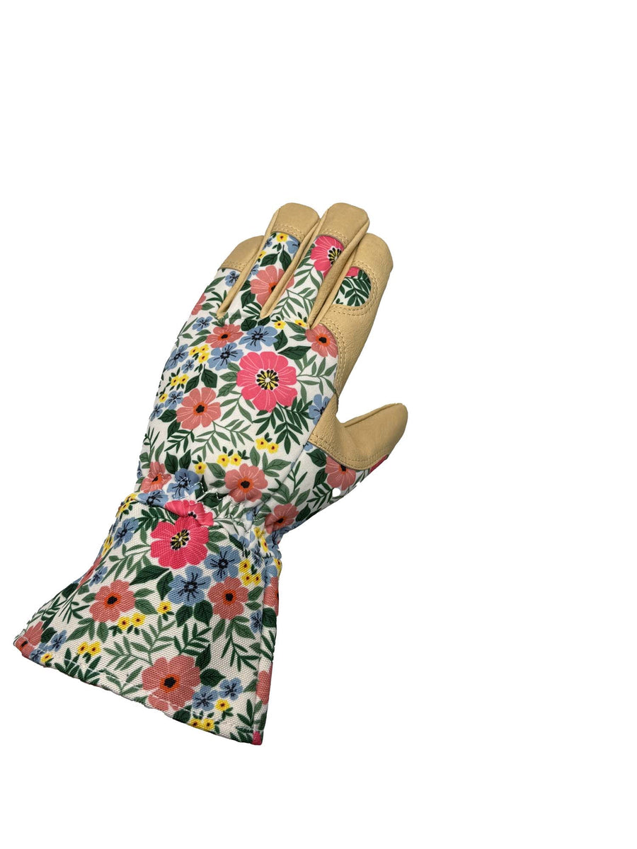 Single floral-patterned gardening glove with tan leather palm and cuff, angled view