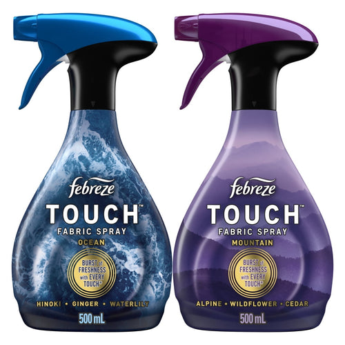 Two Febreze Touch fabric spray bottles side-by-side showing Ocean (blue) and Mountain (purple) scent labels and trigger tops.