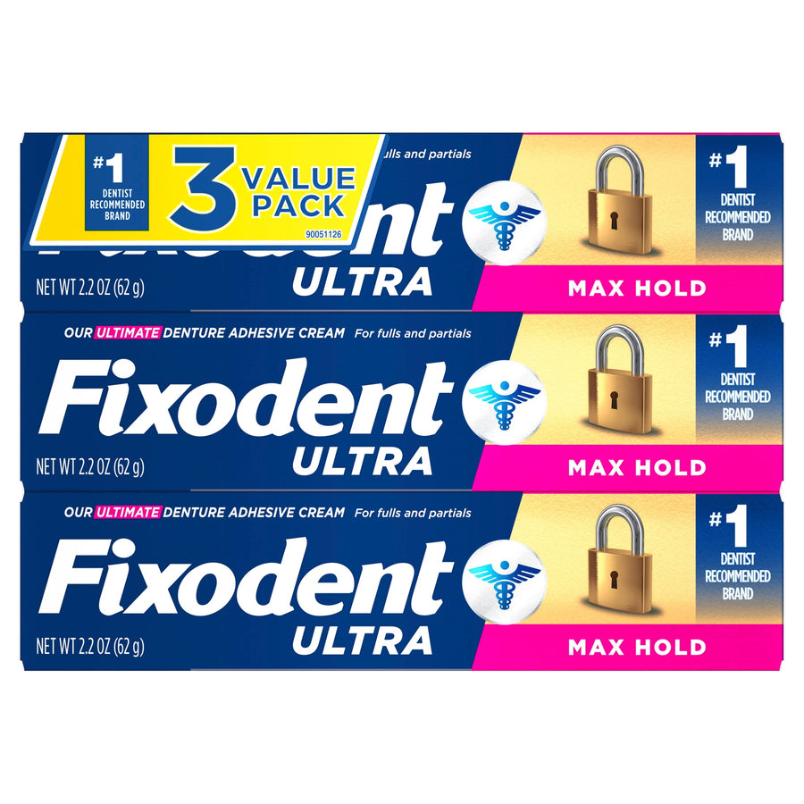 Three stacked Fixodent Ultra denture adhesive cream boxes showing 3-value pack and Max Hold branding