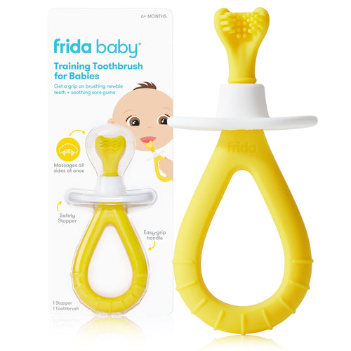 Frida Baby yellow silicone training toothbrush in packaging with white safety stopper and illustrated card backing