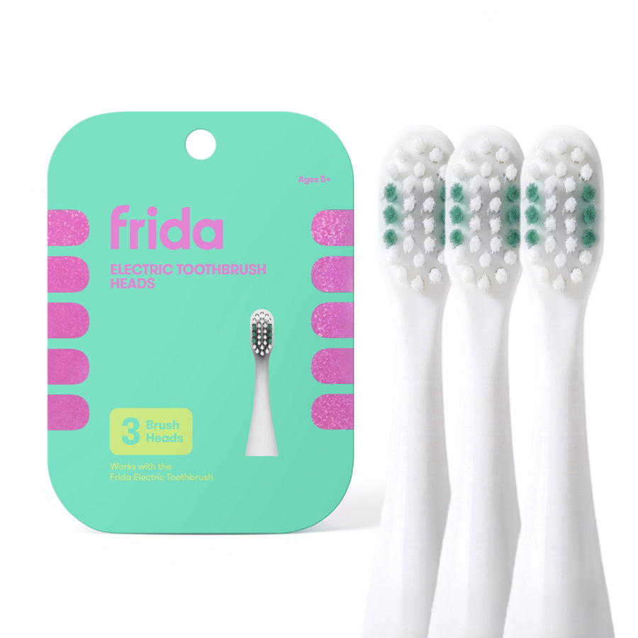 Frida branded mint-green card package for electric toothbrush replacement heads with three white brush heads shown