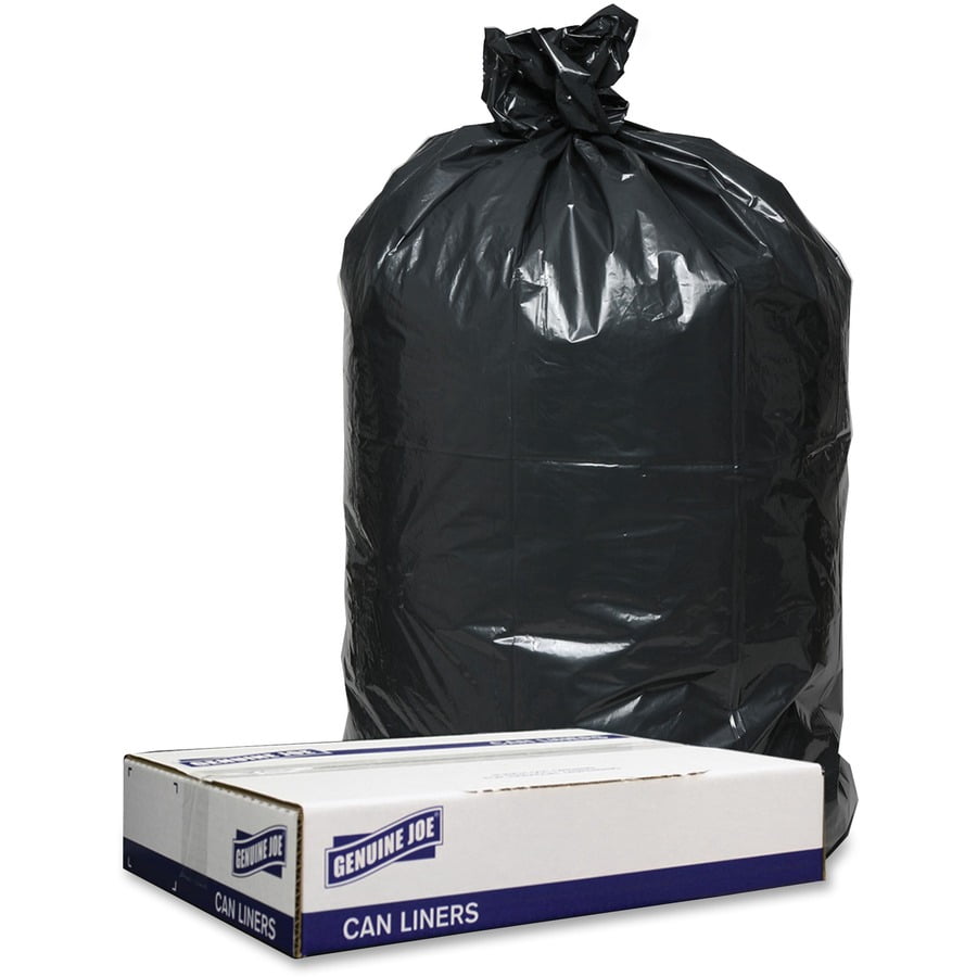 Tied black trash bag standing behind a Genuine Joe cardboard box labeled “Can Liners.”