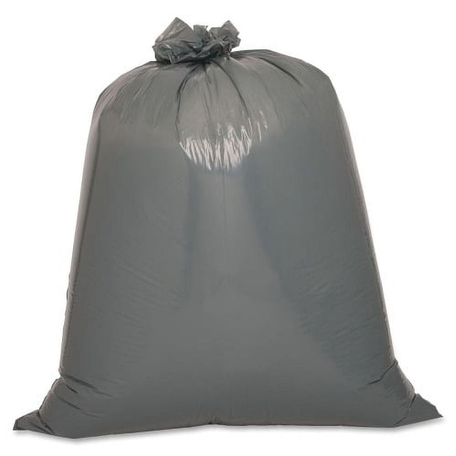 Tied dark gray trash bag filled and standing upright on white background