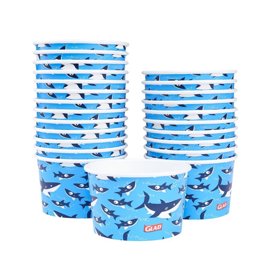 Two stacks of Glad shark-pattern paper snack bowls with one bowl placed in front showing design