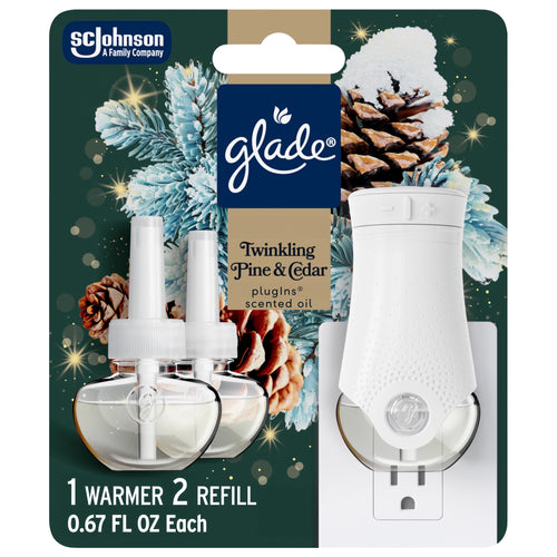 Glade PlugIns starter kit blister card showing white plug-in warmer and two clear scented oil refills with pine and cedar holiday artwork