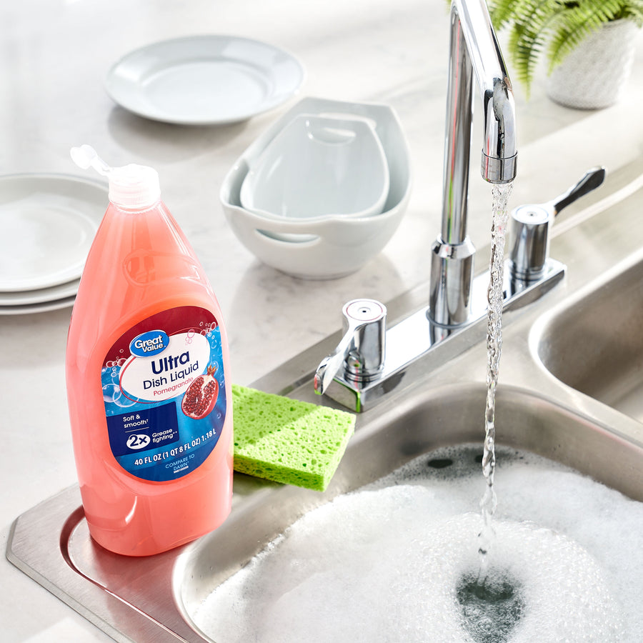 Great Value Ultra Dish Liquid bottle next to a kitchen sink, sponge and soapy water in a lifestyle scene