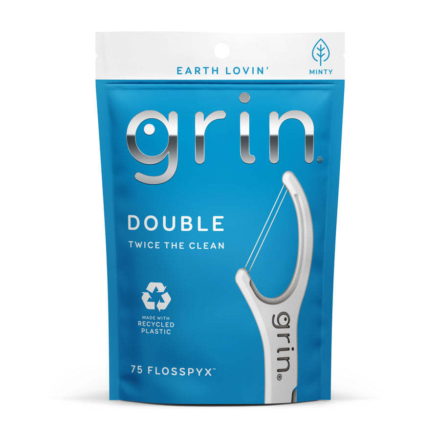 Blue resealable pouch of Grin Double Flosspyx with large white floss pick graphic and recycled-plastic symbol