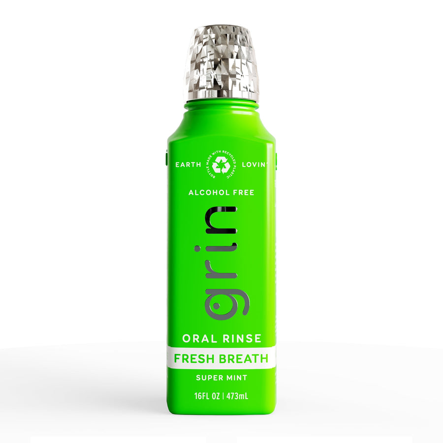 Bright green Grin Fresh Breath oral rinse bottle with silver textured cap on white background.