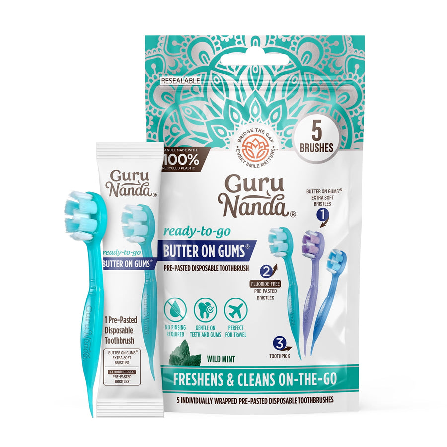 Guru Nanda resealable pouch and individually wrapped travel toothbrush with mint packaging and two loose mini brushes visible.