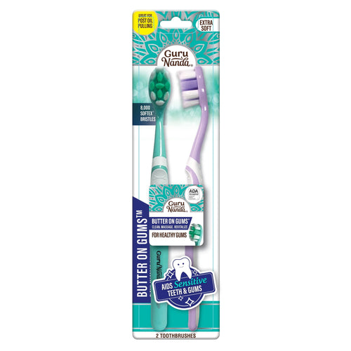 GuruNanda branded retail blister pack showing two soft-bristle 'Butter on Gums' toothbrushes in teal and lavender