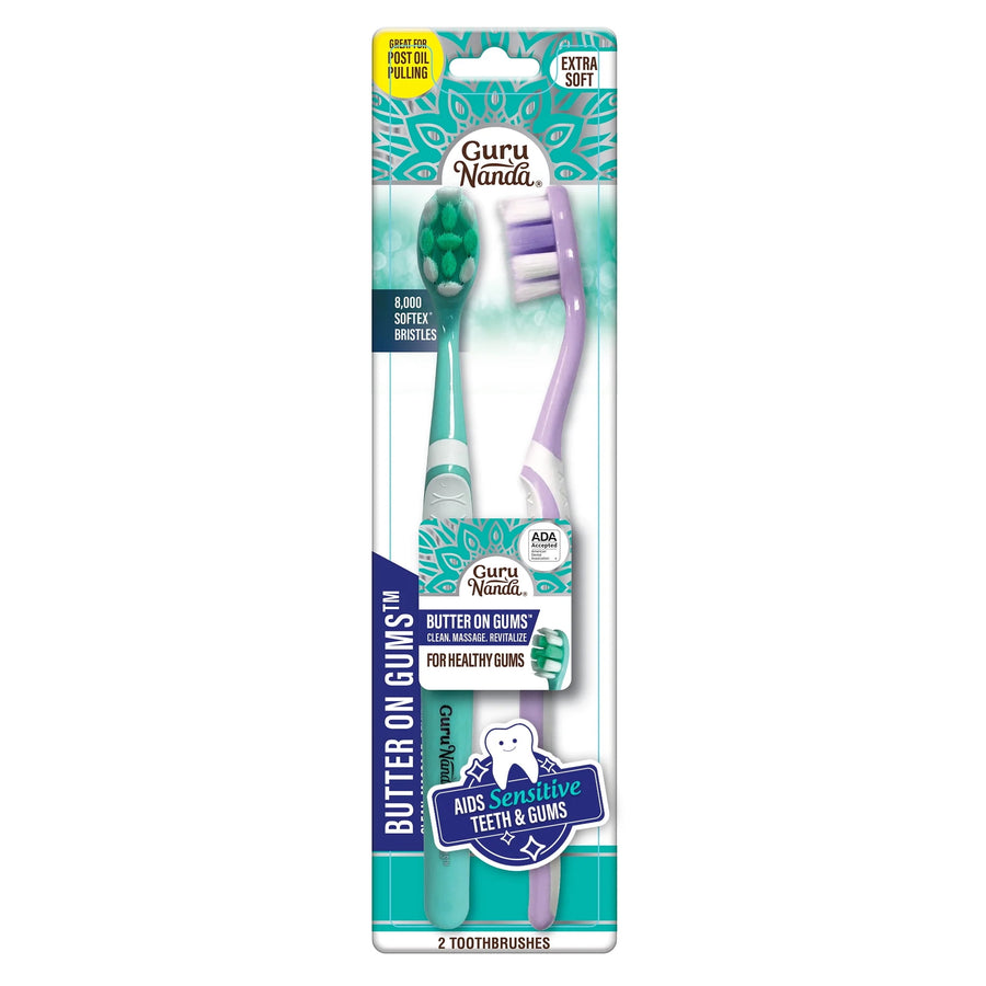 GuruNanda branded retail blister pack showing two soft-bristle 'Butter on Gums' toothbrushes in teal and lavender