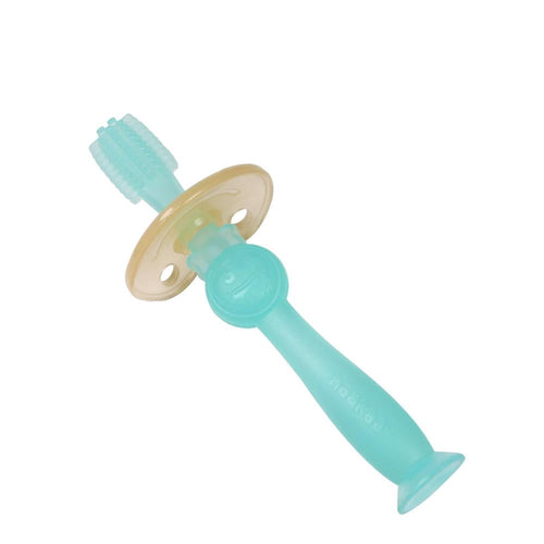 Translucent blue Haakaa silicone 360 baby toothbrush with suction base on white
