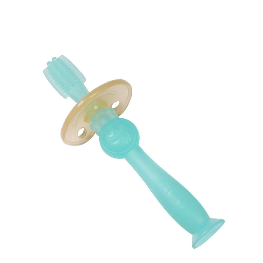 Translucent blue Haakaa silicone 360 baby toothbrush with suction base on white