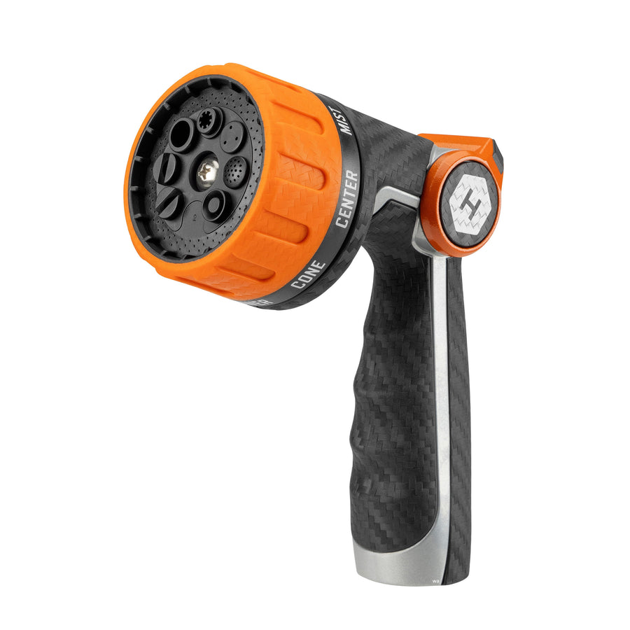 Close-up of an orange-and-black HydroTech heavy-duty hose nozzle angled to show spray head and ergonomic grip