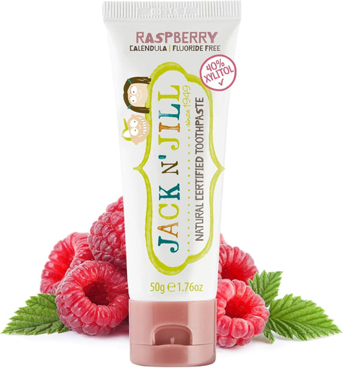 Jack N' Jill raspberry toothpaste tube standing on raspberries, white tube with green logo and pink cap