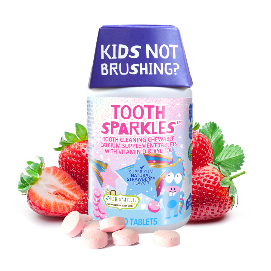 Jack N' Jill Tooth Sparkles bottle with purple cap surrounded by strawberries and pink chewable tablets in front