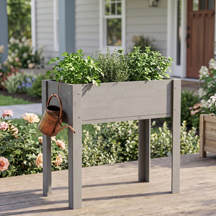 Leumius grey elevated wooden planter filled with herbs, standing on a wooden porch with a watering can hanging