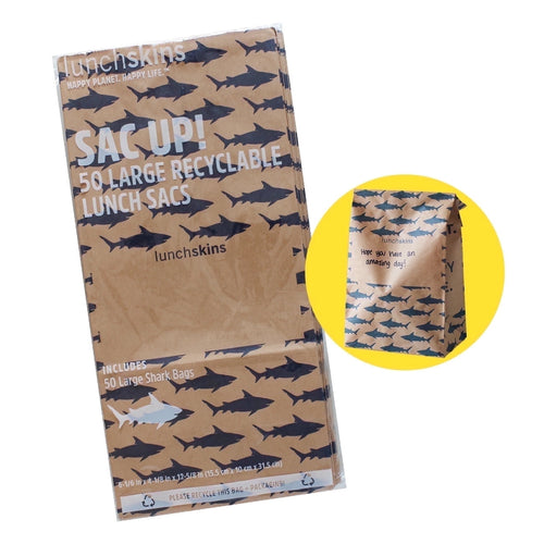Packaged stack of brown kraft Lunchskins bags with repeating shark print and white text
