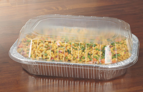 Rectangular aluminum baking pan filled with pasta and covered by a clear plastic hinged lid on a wood surface